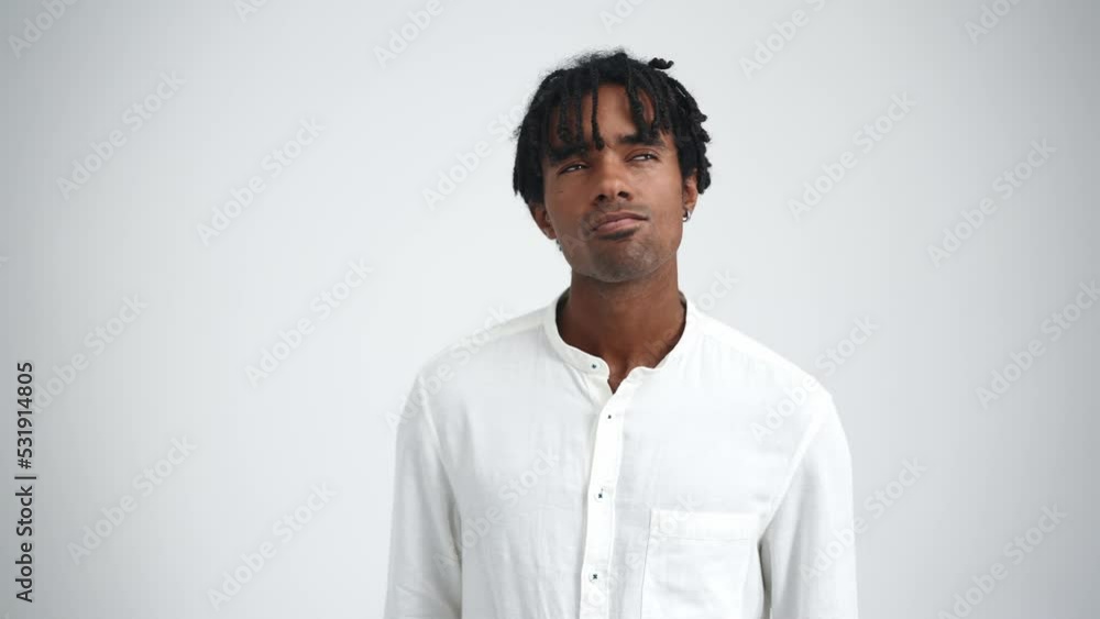 Meditative African man with dreadlocks thinking in the white studio Meditative African man with dreadlocks thinking in the white studio