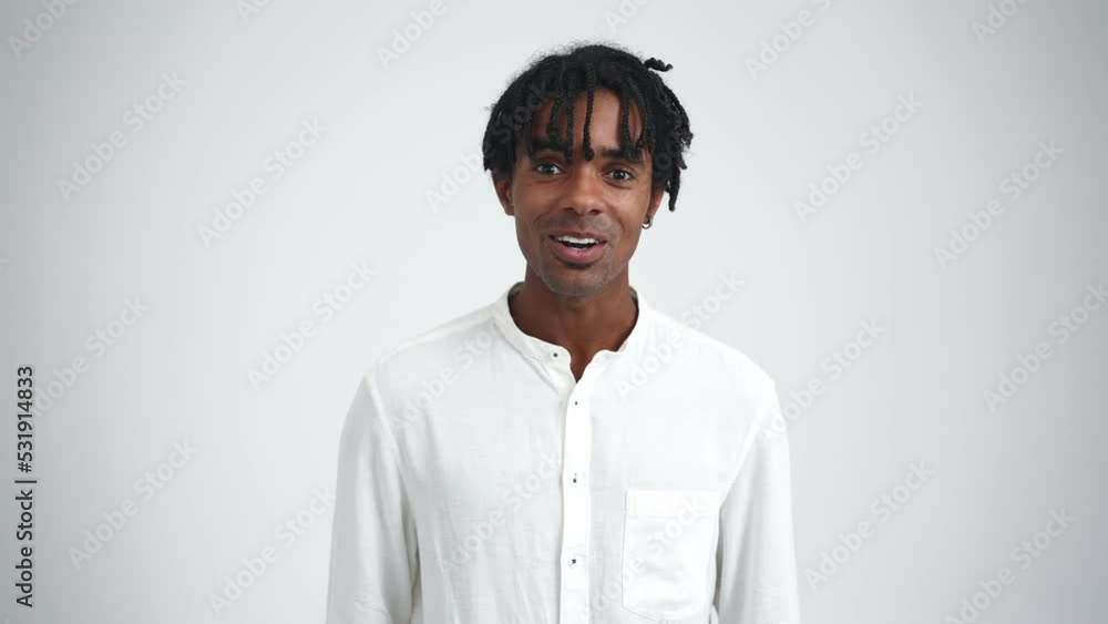 Happy African man with dreadlocks talking at the camera in the white studio Happy African man with dreadlocks talking at the camera in the white studio