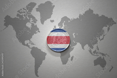 euro coin with national flag of costa rica on the gray world map background.3d illustration. photo