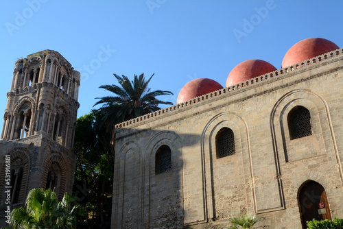 Italy – Palermo – July 15, 2022:The red domes of the church of San Cataldo in Byzantine and Arab-Norman architecture near the Martorana in Piazza Bellini and Palermo skyline.