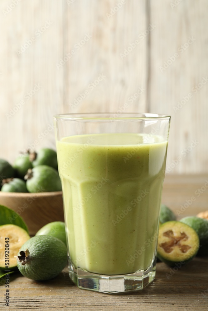 Fresh feijoa smoothie and fresh fruits on wooden table, closeup Fresh feijoa smoothie and fresh fruits on wooden table, closeup