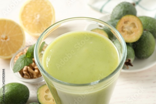 Freshly made feijoa smoothie in glass on light table, closeup