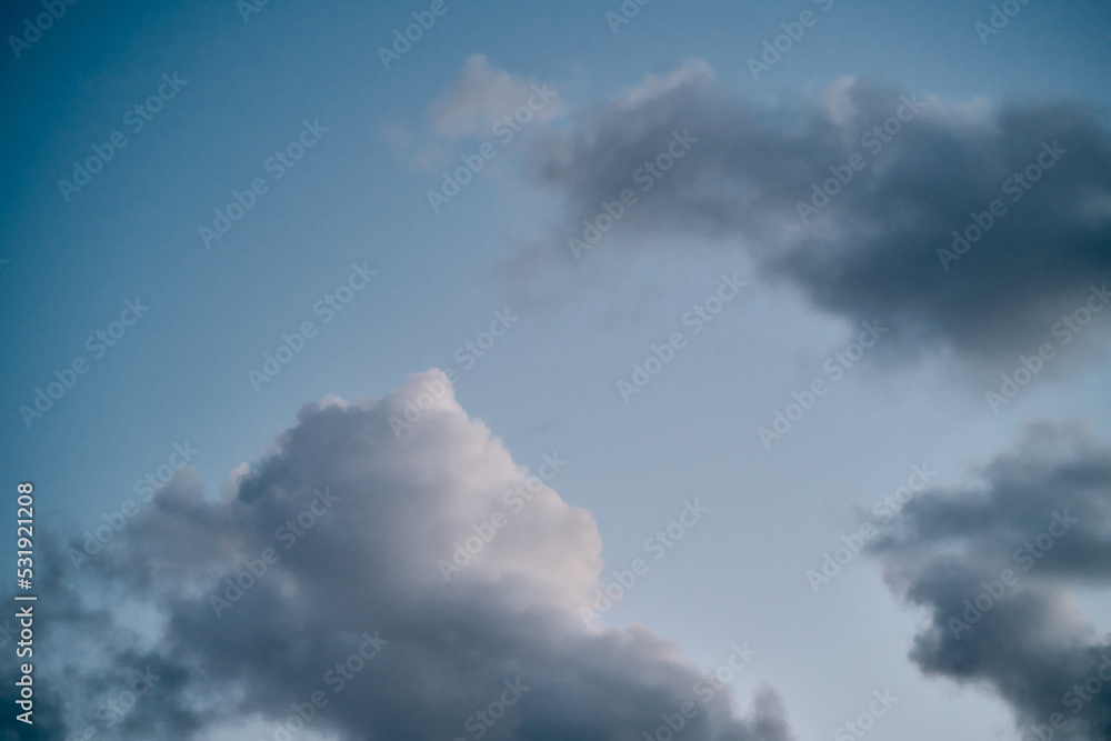 Backdrop of a white cloud in a blue summer sky. Natural background with soft clouds.