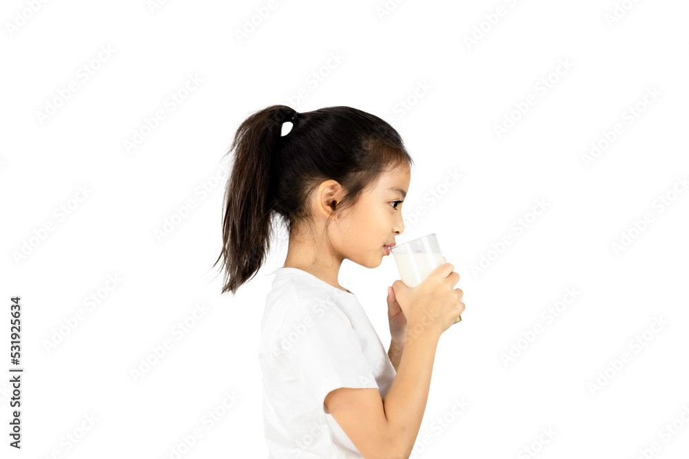 Side viwe of young Asian girl in white t-shirt drinking milk from a glass isolated on white background with clipping path. Side viwe of young Asian girl in white t-shirt drinking milk from a glass isolated on white background with clipping path.