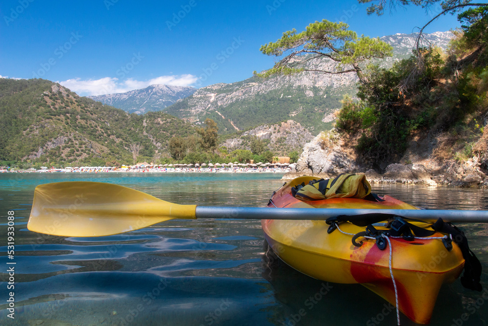 Beautiful view on nature mediterranean, mountains , beach from yallow kayak. Activ travel on the coasline Turkey on kayak. Blue lagoon in Oludeniz.