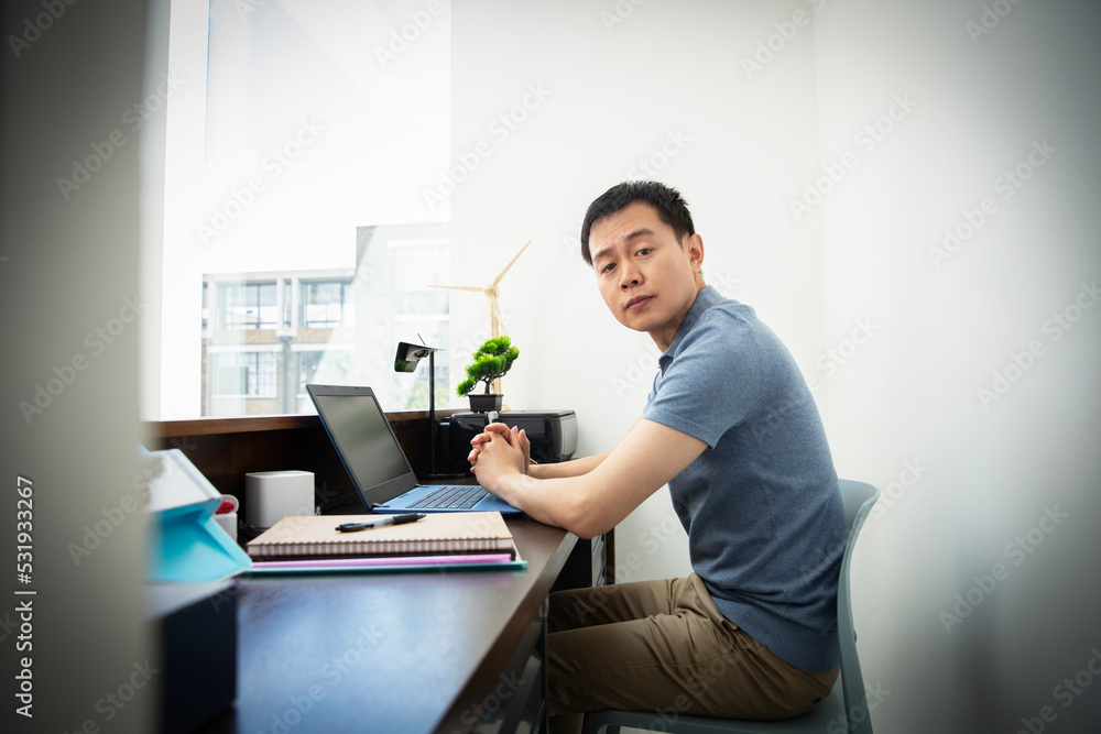Portrait confident male engineer working at laptop in office Portrait confident male engineer working at laptop in office