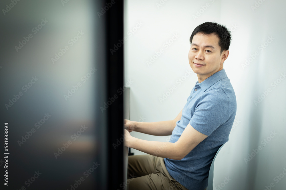Portrait smiling businessman in office doorway Portrait smiling businessman in office doorway