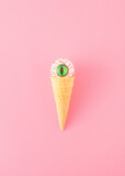 Creative aesthetic concept made of a cone and a bloody eye instead of a scoop of ice cream on a pink background. Minimal Halloween arrangement.