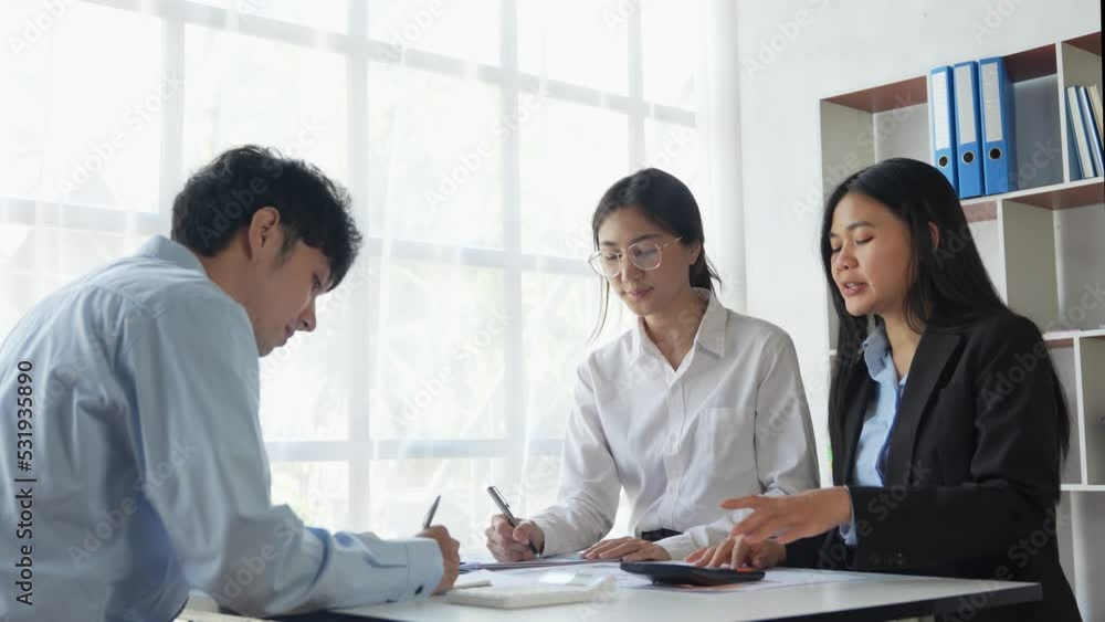 Group of young Asian businesspeople brainstorming meeting to discuss planning strategies new business development working on a new startup project in the office. Group of young Asian businesspeople brainstorming meeting to discuss planning strategies new business development working on a new startup project in the office.