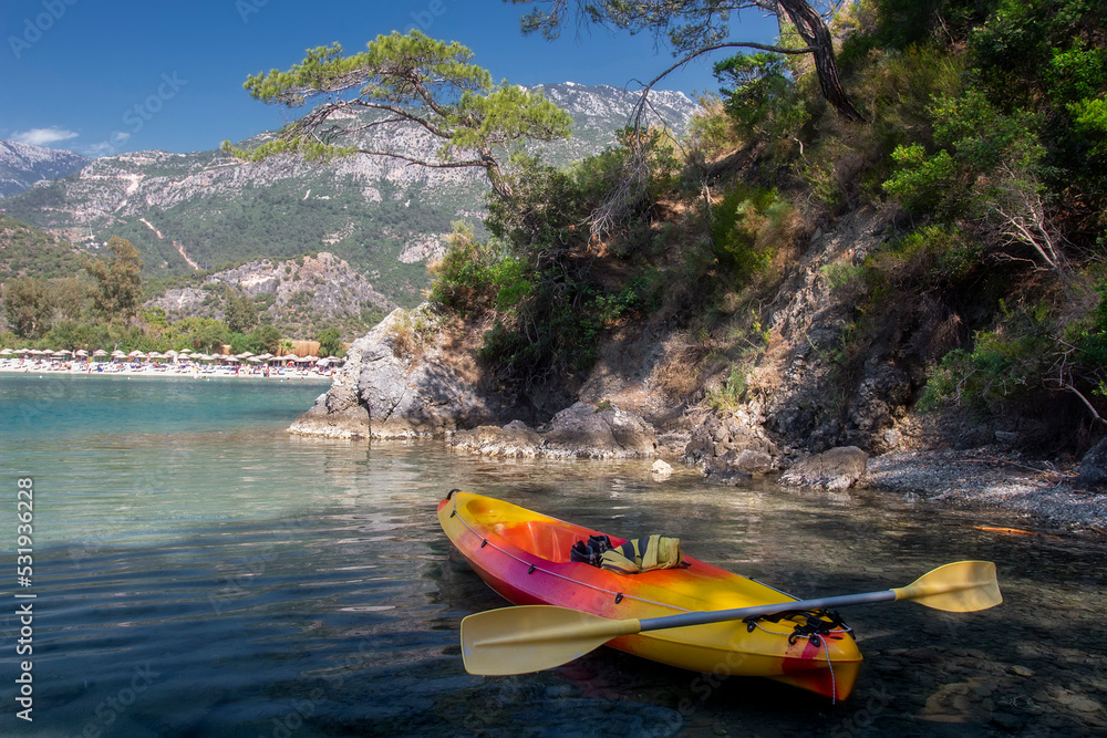 Summer landscape on mediterranean place near Oludeniz, Turkey. Amazing travel on kayak on the sea. Stopping on rocky coastline.