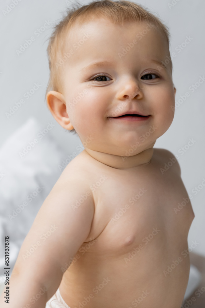 Portrait of smiling baby girl looking at camera on blurred bed. Portrait of smiling baby girl looking at camera on blurred bed.