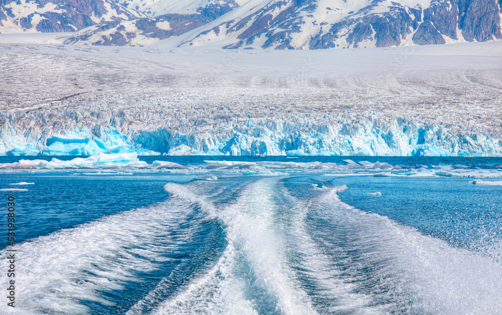 Waves of blue sea behind the speedboat water - Background water surface behind of fast moving motor boat across the     Knud Rasmussen Glacier near Kulusuk - Greenland, East Greenland 