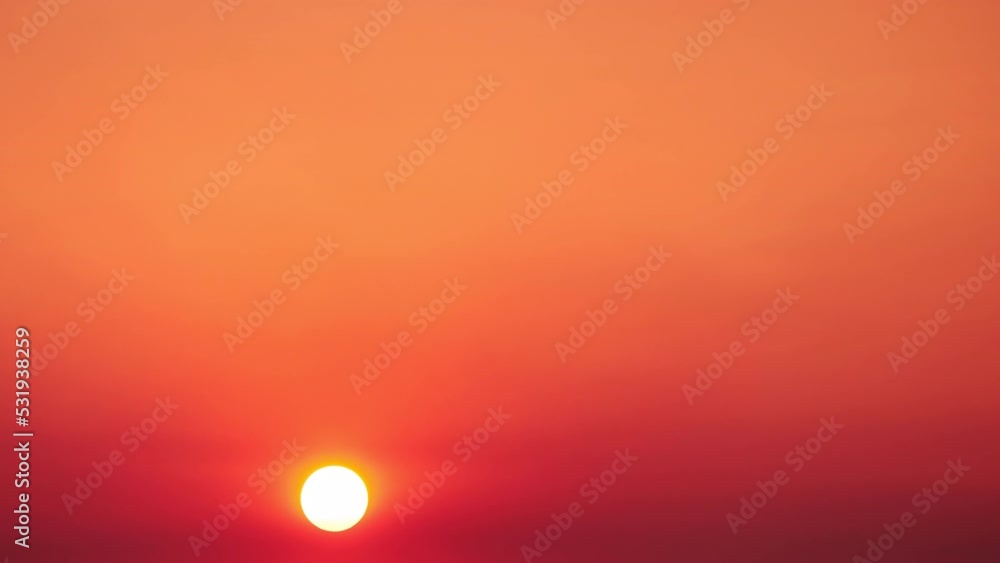 A big red sun in the dawn sky, a hot summer landscape. Morning sky in bright sunlight A big red sun in the dawn sky, a hot summer landscape. Morning sky in bright sunlight