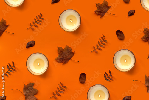 Burning vanilla candle pattern. Warm aesthetic Halloween autumn, thanksgiving day composition with dry leaves. Home comfort, spa, wellness concept. Interior decoration, festive texture for packaging