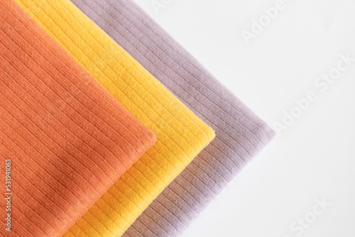 Stack folded colorful baby cotton clothing on white background isolation. Copy space. For advertising, commercial,mock up.