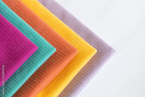 Stack folded colorful baby cotton clothing on white background isolation. Copy space. For advertising, commercial,mock up.