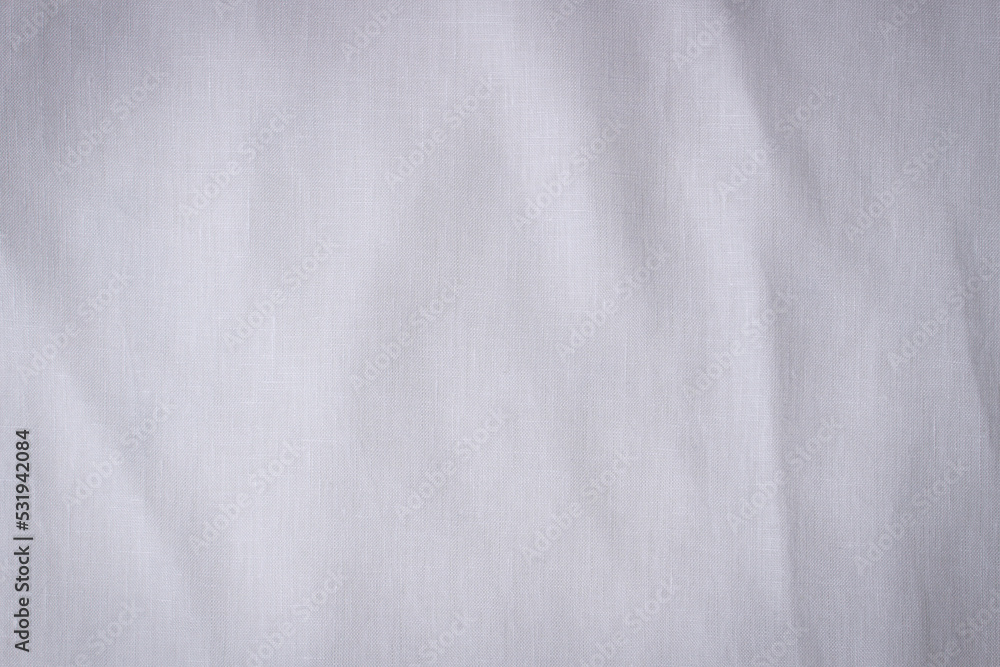 White crumpled linen fabric texture background. Natural linen organic eco textiles canvas background. Top view