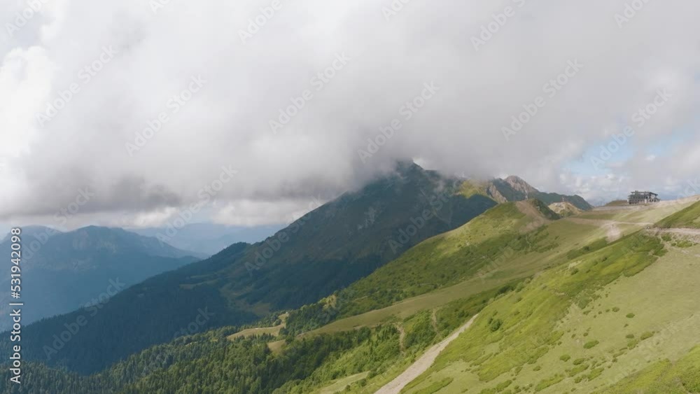 Flight over green hills and mountains. Drone video footage on a sunny summer day. Sky and thick clouds Flight over green hills and mountains. Drone video footage on a sunny summer day. Sky and thick clouds