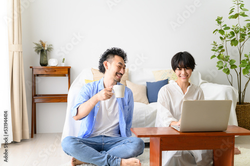 Woman looking for something on the computer with her husband.