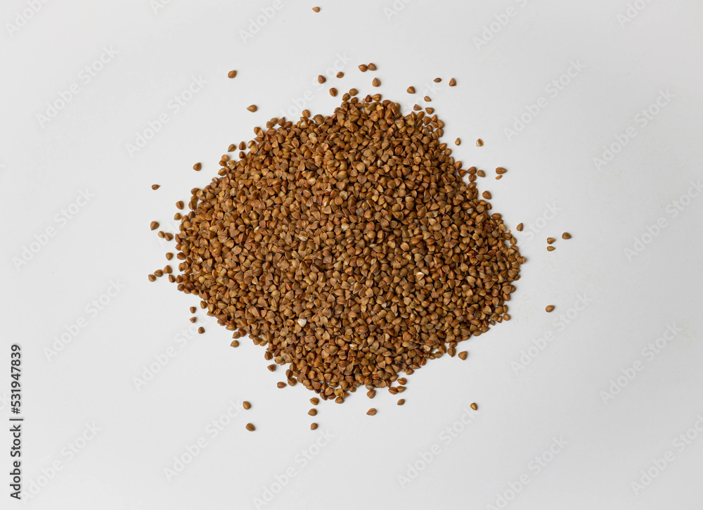 Buckwheat on a white background. Buckwheat texture close up. Buckwheat on a white background. Buckwheat texture close up.