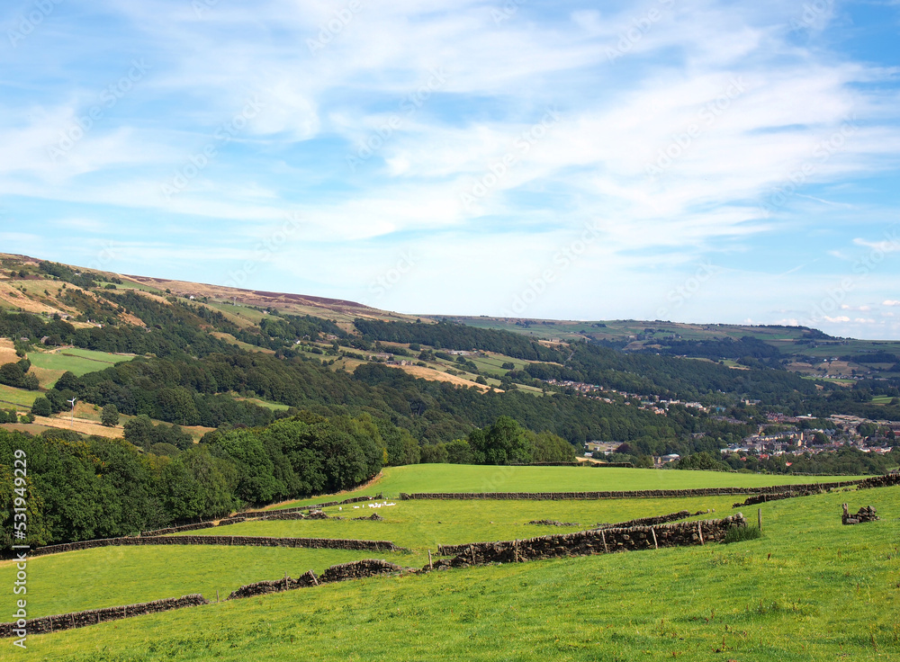 Obraz premium view of the calder valley in calderdale west yorkshire with the village of mytholmroyd visible in the distance