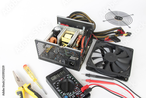 repair of a disassembled Computer Power Supply Unit, on a white background