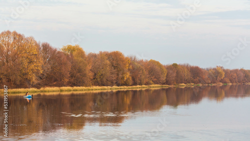 Kolomna, Moscow region, Russia - 20 October 2019: Autumn panoramic view over river and a boat with fishermen