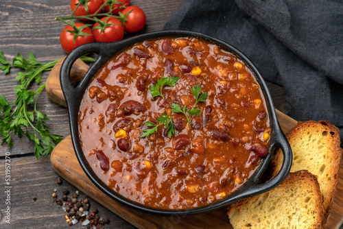 Bean and corn soup or ragout, red bean stew on a wooden background. Food Protein Vegan dish