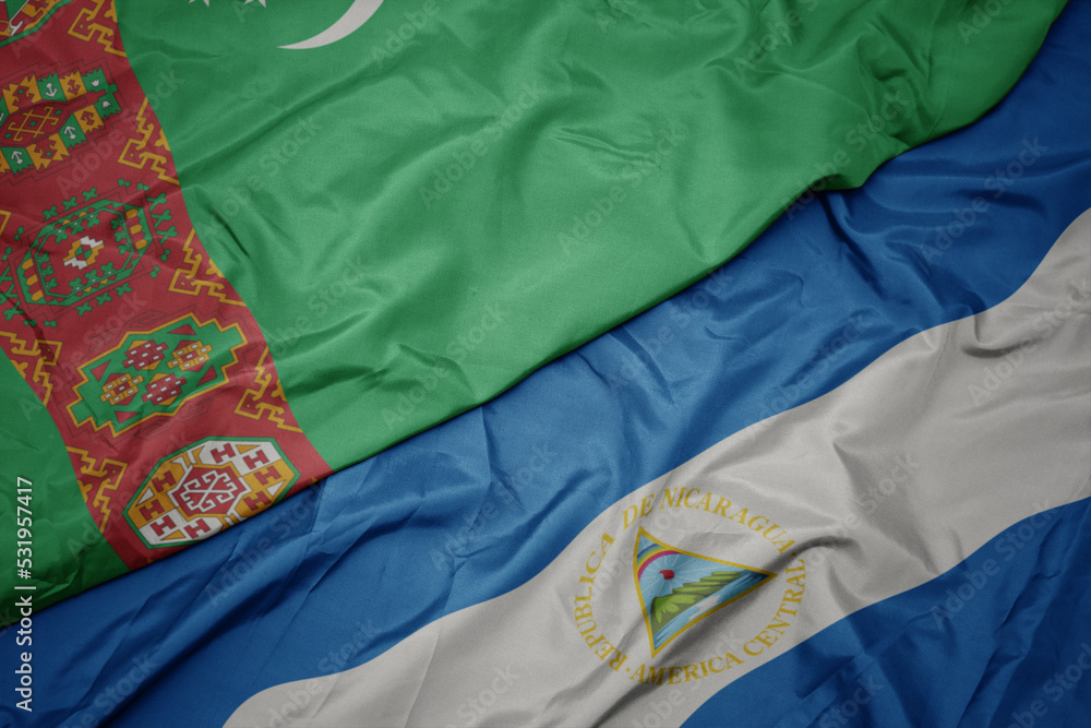 waving colorful flag of turkmenistan and national flag of nicaragua. 3d illustration