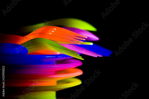 colorful cutleries against a black blackdrop