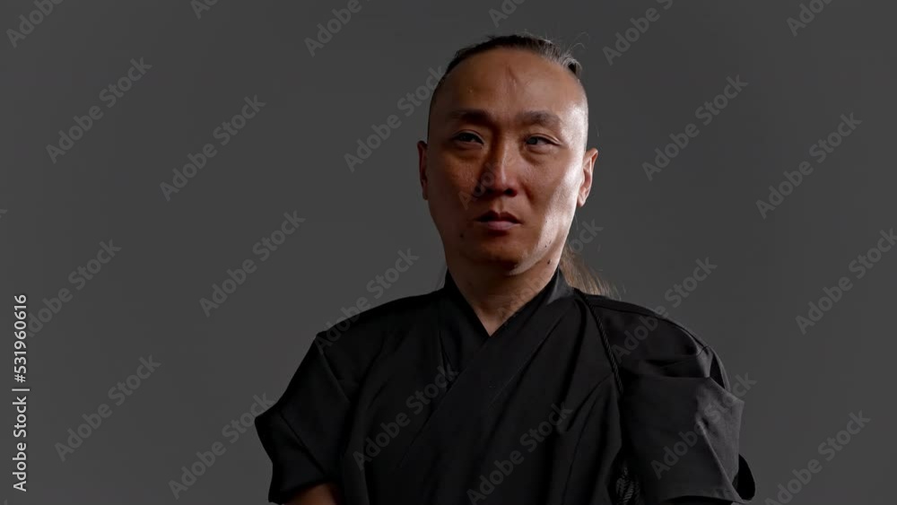 Japanese traditional dress pulls out katana sword scabbard. Shows shiny blade intention attack defend. Strength, endurance art combat. Traditional Japan values tribute culture. Stern look stylish hand Japanese traditional dress pulls out katana sword scabbard. Shows shiny blade intention attack defend. Strength, endurance art combat. Traditional Japan values tribute culture. Stern look stylish hand