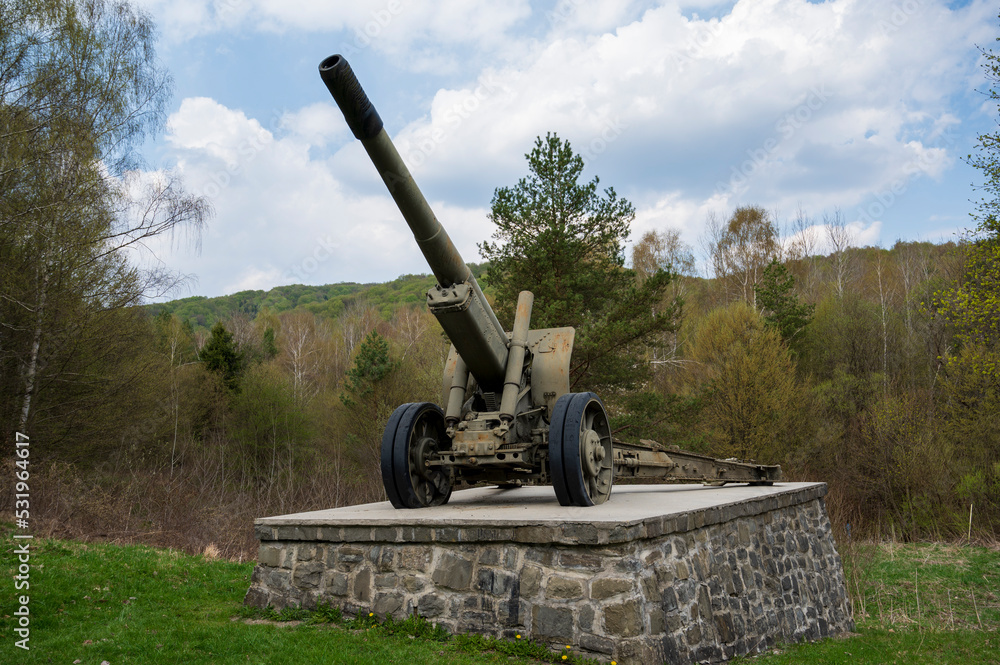 Cannon from the Second World War in forest on concrete base. Cannon from the Second World War in forest on concrete base.