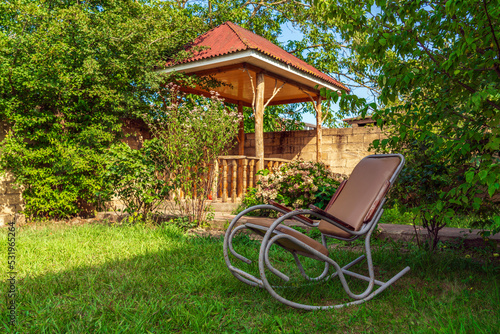 Rocking chair in the garden of a country house