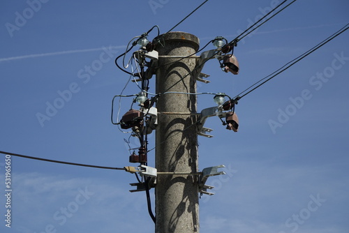 Head of concrete power pole and with wires and isolators, blue spring sky, concept: supply, electricity (horizontal), Wolfstein, RLP, Germany
