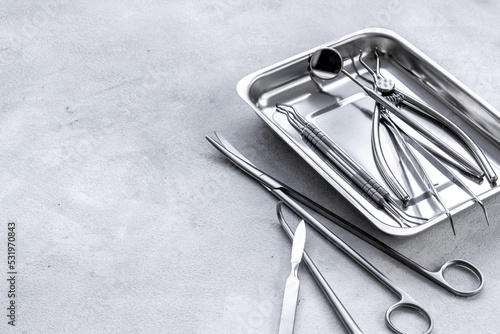 Stack of surgical medical steel equipment at surgery desk photo