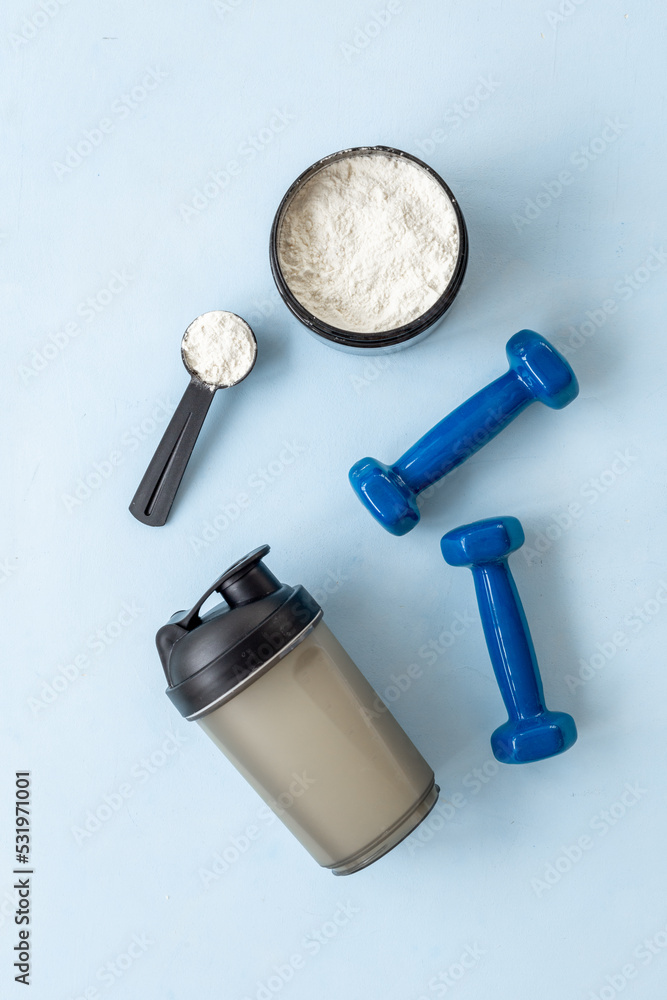 Sport bottle and jar of powder whey protein and dumbbells. Fitness and gym diet Sport bottle and jar of powder whey protein and dumbbells. Fitness and gym diet