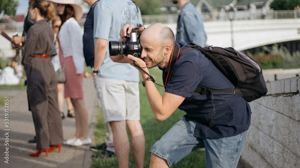 young man with a camera taking a photo during an excursion. young man with a camera taking a photo during an excursion.