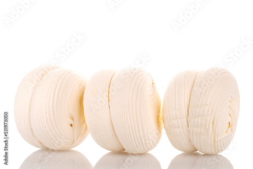 Three sweet white marshmallows, macro, isolated on white background.