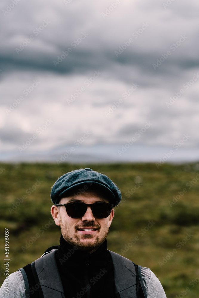 Hiker with sunglasses and baret in the Scottish Highlands. . High quality photo Hiker with sunglasses and baret in the Scottish Highlands. . High quality photo