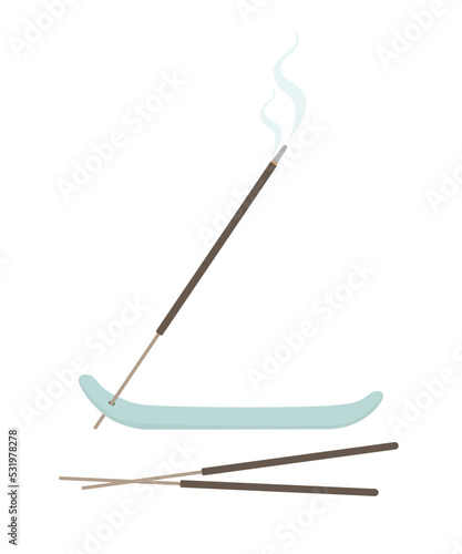 Incense stick burning on a stick holder.