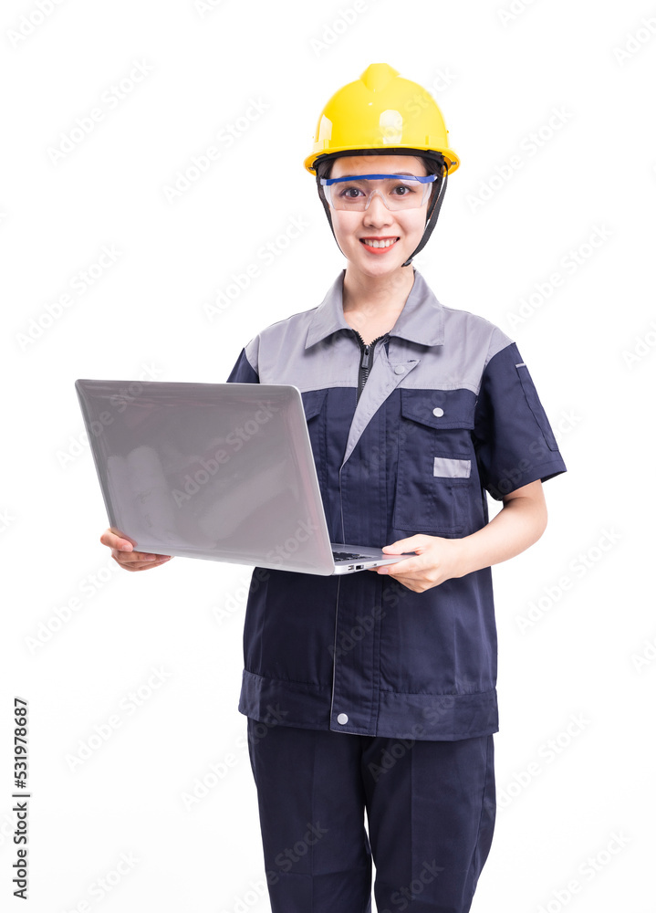 A female worker in a hard hat and uniform holding a computer A female worker in a hard hat and uniform holding a computer