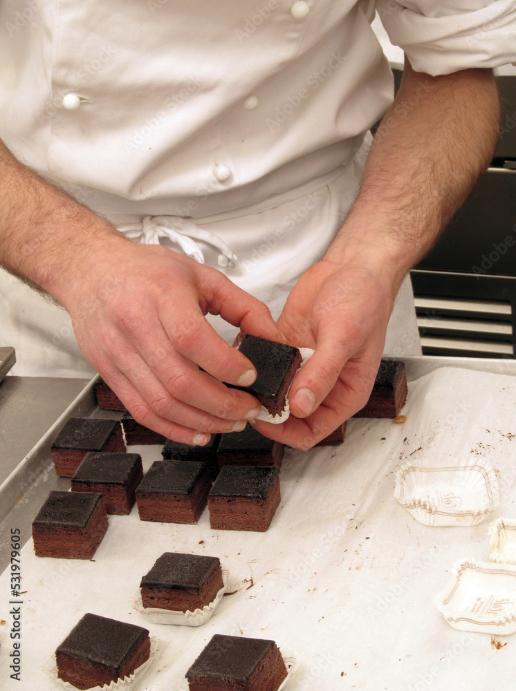 Pastry chef preparing and making chocolate sweets