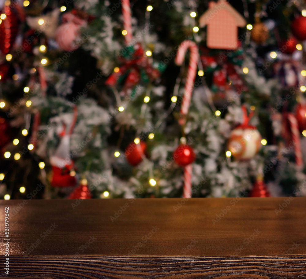 Christmas background. Empty wooden table on the background of the Christmas tree and New Year's bokeh.Ready for product montage. Banner.Mockup. Christmas background. Empty wooden table on the background of the Christmas tree and New Year's bokeh.Ready for product montage. Banner.Mockup.