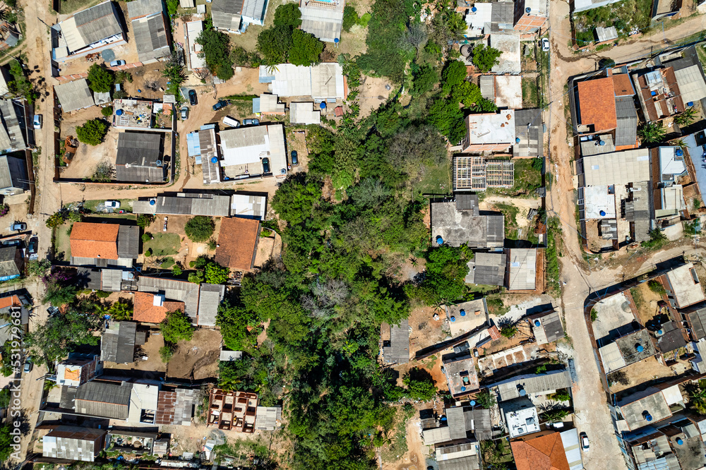 Fototapeta premium Aerial view of Parque Oziel neighborhood (also known as Jardim Monte Cristo) in Campinas, São Paulo. Poor community with wooden houses, garbage and vegetation in its surroundings.