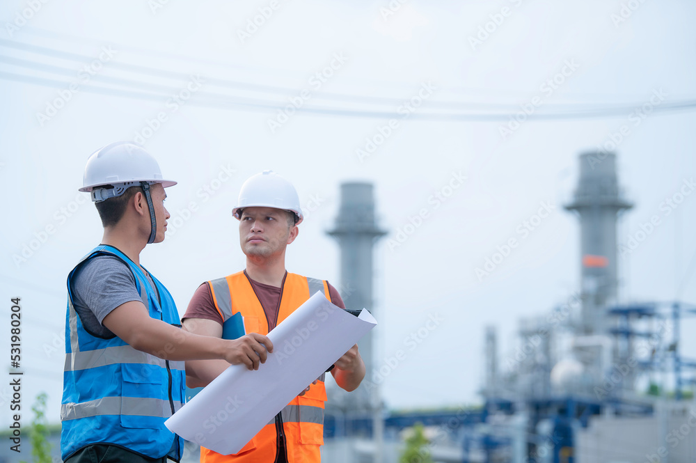 Two engineer working at power plant,Work together happily,Help each other analyze the problem,Consult about development guidelines Two engineer working at power plant,Work together happily,Help each other analyze the problem,Consult about development guidelines