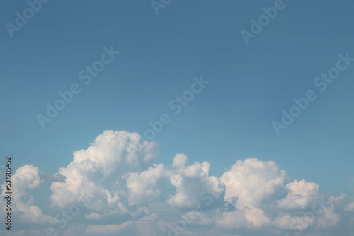 Clear blue sky with cumulus clouds