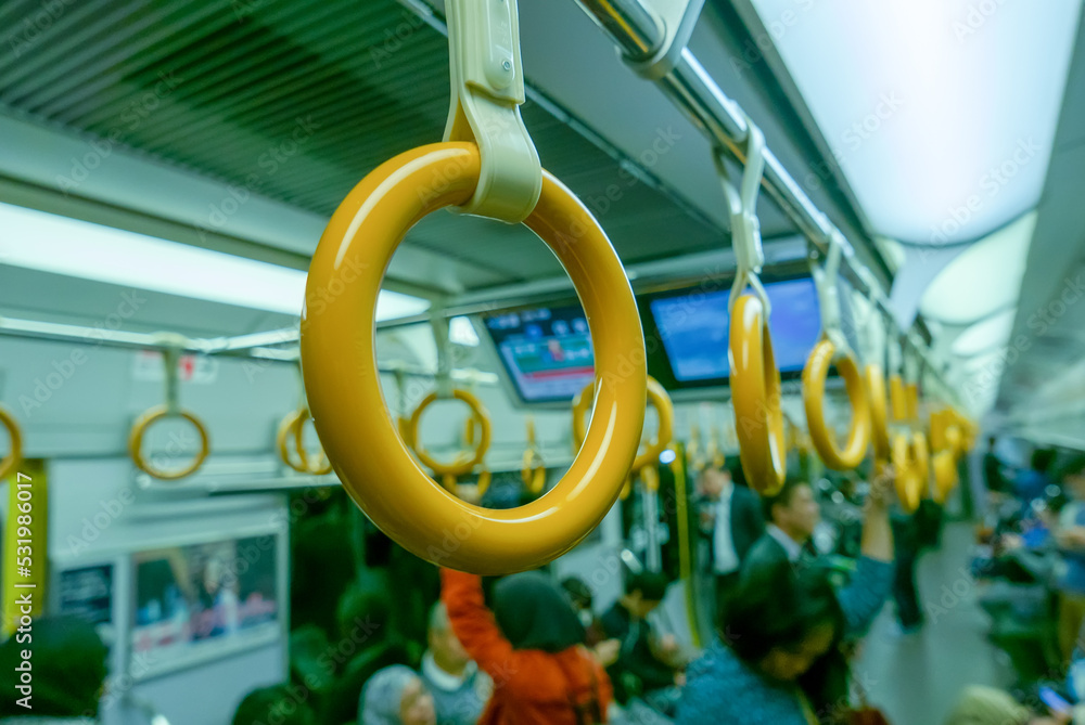 Yellow train hand strap inside a train in Japan. Yellow train hand strap inside a train in Japan.