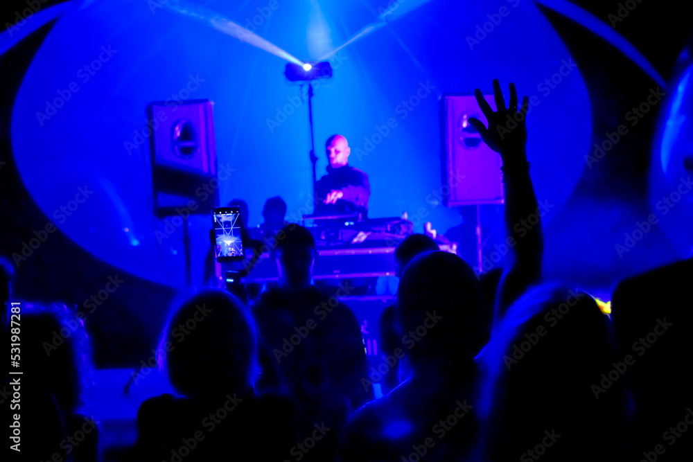 Male DJ mixing music in nightclub