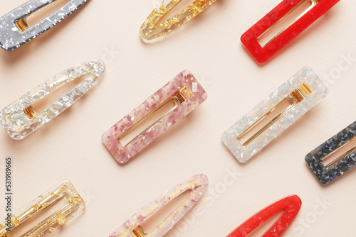 Fashionable, stylish colored hair clips on a colored background