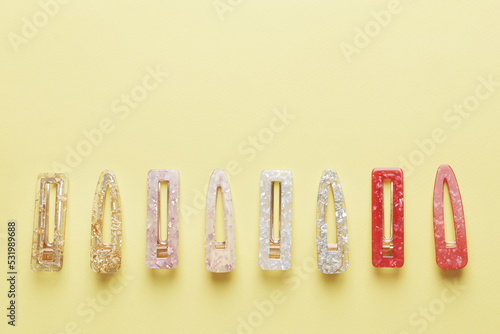 Fashionable, stylish colored hair clips on a colored background photo